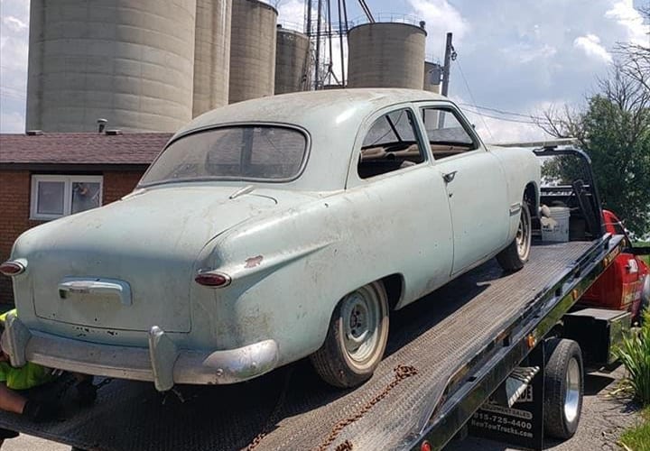 Area 47 Towing vintage car on flatbed trailer