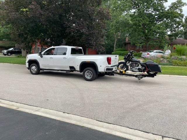 Area 47 Towing white pickup towing motorcycle trailer
